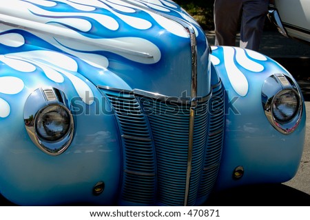 Front of vintage car, white with blue flames paint job