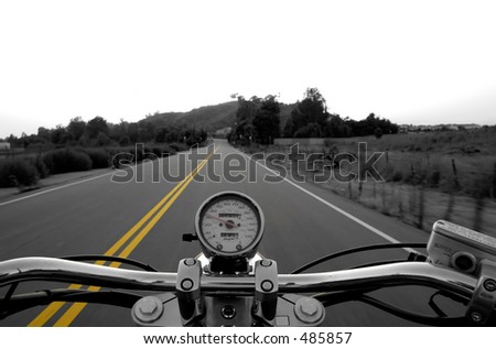 Motorcycle moving on a straight road from rider\'s perspective