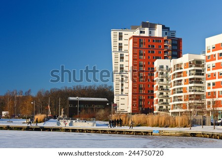 Vasteras, Sweden - December 25: People walking a cold sunny winter day along lake Malaren at the fashionable part of Vasteras, on December 25, 2014 in Vasteras, Sweden.