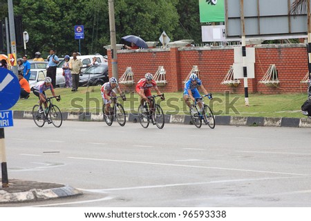 KUANTAN - MARCH 1: First group cyclists take last corner during Stage 7 of the le Tour de Langkawi from Bentong to Kuantan on March 1, 2012 in Kuantan, Pahang, Malaysia.