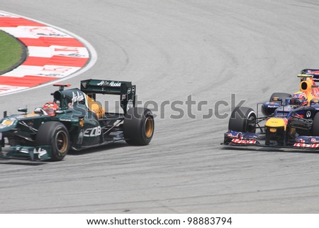 SEPANG, MALAYSIA - MARCH 23: Heikki Kovalainen of Caterham and Mark Webber of Red Bull Racing in action during Friday practice at Petronas Formula 1 Grand Prix on March 23, 2012 in Sepang, Malaysia