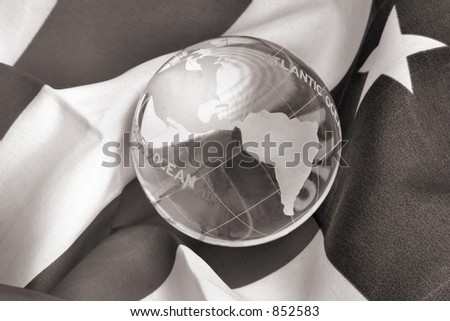 Glass Globe on American Flag in B&W. Conceptual image for stock market, trade, commerce, DOW, global economies, democracy, freedom, etc.