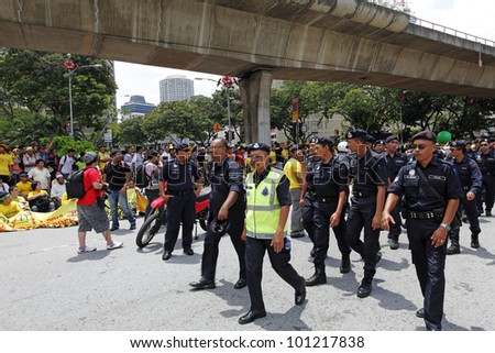 KUALA LUMPUR, MALAYSIA - APRIL 28: Police patrol at the protest rally organized by the coalition for clean & fair election in Dataran Merdeka on April 28, 2012 in Jln Parlimen, Kuala Lumpur, Malaysia.