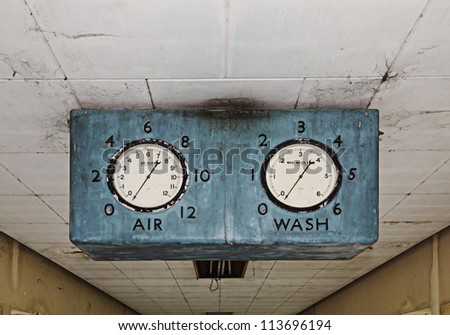 Old grungy industrial meter in a water treatment plant hanging on the operational room ceiling.
