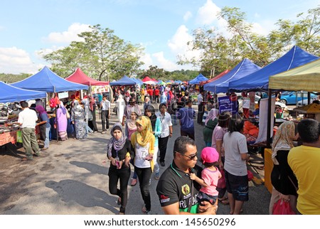 SHAH ALAM, MALAYSIA - JULY 11: Shoppers at a Ramadan food bazaar on July 11, 2013 in Shah Alam, Malaysia. The food bazaar is established for Muslim to break fast during the holy month of Ramadan.