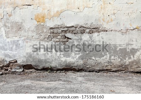 Decaying weathered cement brick wall with blank space for text.