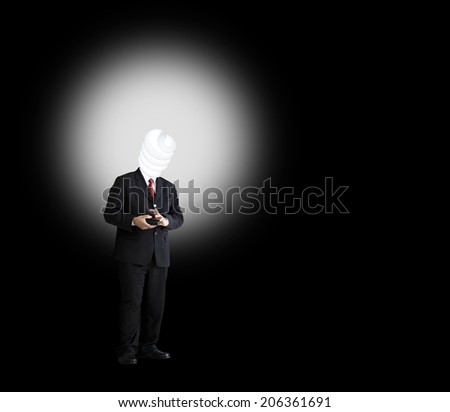 A man in a black executive suit with a light bulb head that is glowing in the dark, for the concept of Executive Power.