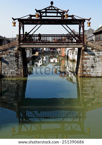 TONGLI, CHINA - JANUARY 2, 2015: A traditional ancient chinese bridge across a canal in the ancient town of Tongli, China. The town is placed under China National Key Cultural Relic Protection Unit.