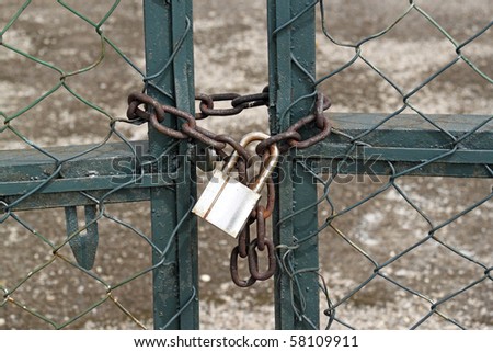 No entry via this padlocked chain linked fence gate.