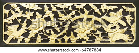An ancient golden lacquered oriental motif wood carving on chinese hardwood door panel.