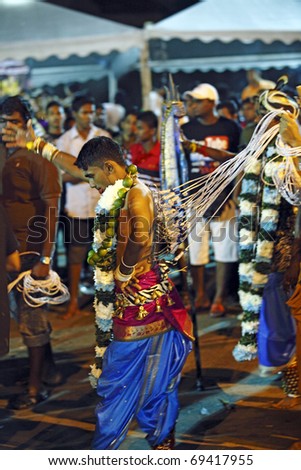 KUALA LUMPUR - JAN 20: Hindu devotees with painful body piercing on Thaipusam festival on January 20, 2011 in Batu Cave, Kuala Lumpur commemorating Lord Murugan vanquishing the demon Soorapadman