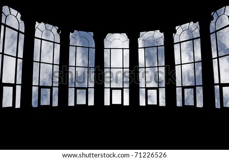 A silhouette of the frame of a large bay window with a view of a blue cloudy sky.