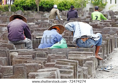BOROBUDUR, INDONESIA - FEB 3: Workers sort out ancient stone masonry block on February 3, 2011 in Borobudur, Indonesia as the ongoing restoration effort of historical Borobudur temple