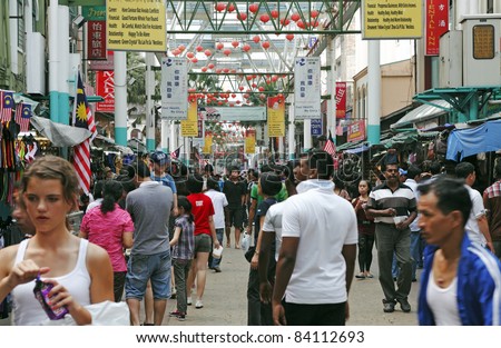 KUALA LUMPUR, MALAYSIA - AUGUST 30: Shoppers in the crowded street bazaar on August 30, 2011 in Chinatown, Kuala Lumpur, Malaysia. The district is earmarked for demolition by 2012 for a new train line