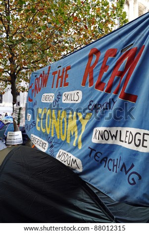 LONDON - NOVEMBER 1: A large blue colored protest banner at the Occupy London Stock Exchange anti-capitalist protest on November 1, 2011 at St Paul\'s Cathedral churchyard in London.