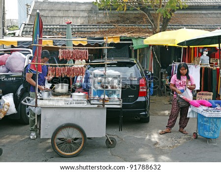 BANGKOK - DECEMBER 24: Street food vendor in a weekend bazaar on December 24, 2011 in Chatuchak Market, Bangkok. Chatuchak Market is the world largest weekend market covering 27acre with 15,000 booths