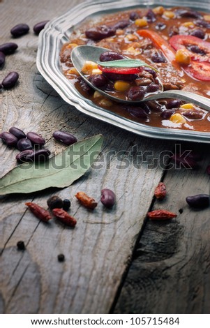 Chili con carne. Restaurant food concept with Mexican traditional dish stew in rustic setting
