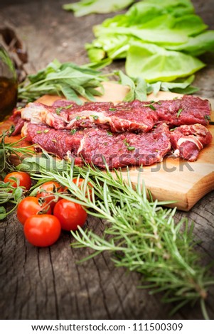 Cooking ingredients: marinated meat,oil,vinegar, herbs and vegetables