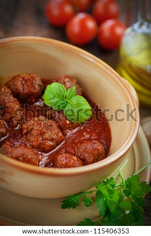 Italian cooking  - meat balls with basil, tomatoes, olive oil and garlic