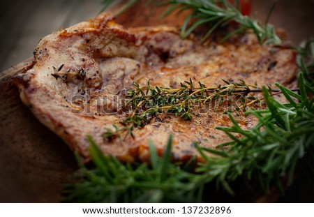 Grilled Pork Steak BBQ with herbs. Barbecue Meat Steak on wood