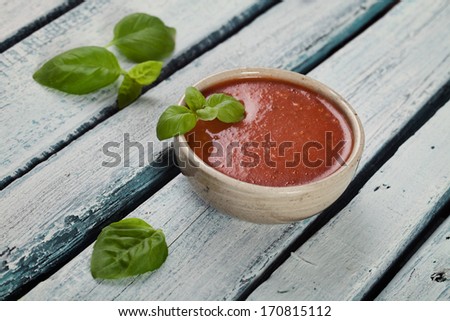 Tomato soup in rustic setting. Vegetable appetizer.