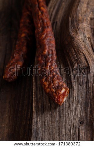 Sausage. Dried Smoked Sausages Sliced on wooden Board. Chorizo sausage