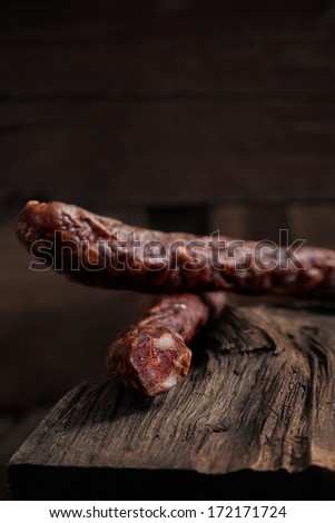 Sausage. Dried Smoked Sausages Sliced on wooden Board. Chorizo sausage