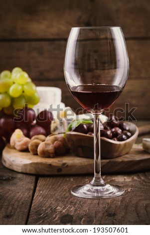 Red wine with Cheese variety. Food background.  Fresh snacks on wood