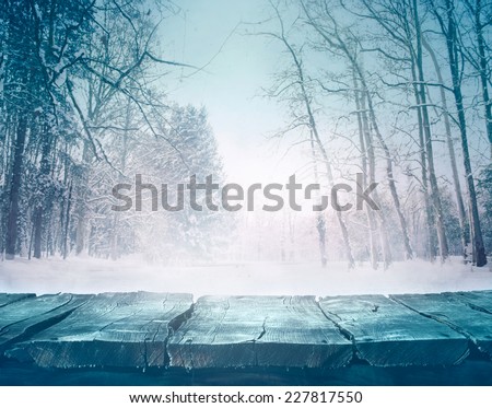 Winter background. Winter snow landscape with wooden table in front.