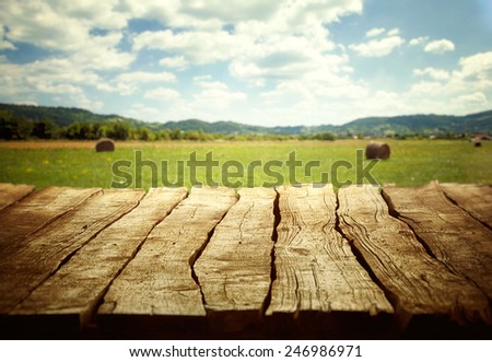 Wooden empty table. Wooden display with spring fields bokeh.