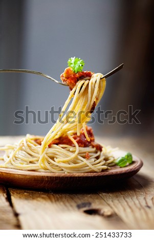 Italian food. Pasta spaghtti with tomato sauce, olives and garnish