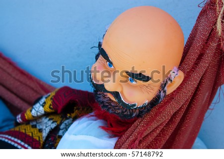 Old doll. Man with beard and indian clothing.