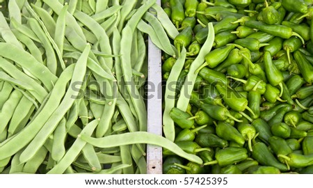 Large pile of french beans and jalapeno peppers on the local market.