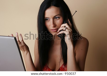 Female speaking with support on cell phone while looking at laptop screen