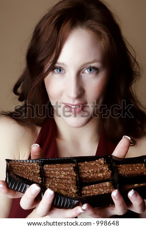 Red hair female holding a box of chocolate