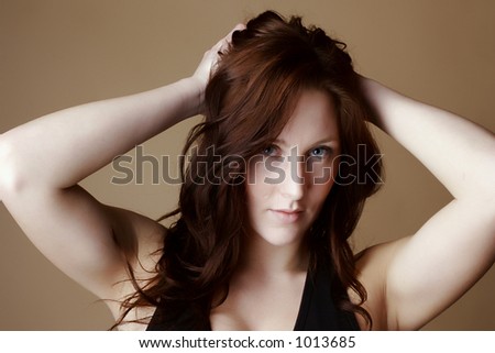 Red hair female with hands over head