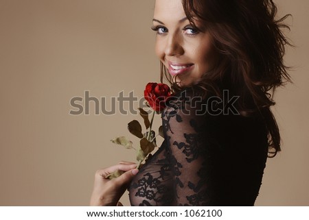 Female dressing a transparent shirt and holding a rose
