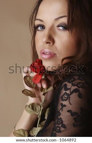 Female dressing a transparent shirt and holding a rose