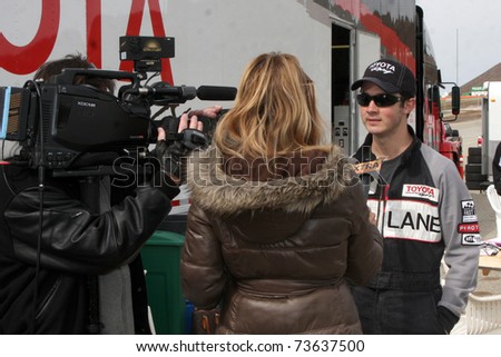 LOS ANGELES - MAR 19:  Extra Interviewing Kevin Jonas at the Toyota Pro/Celebrity Race Training Session at Willow Springs Speedway on March 19, 2011 in Rosamond, CA