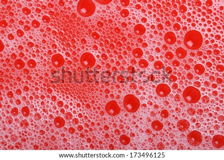 beautiful red background of suds bubbles closeup. macro texture