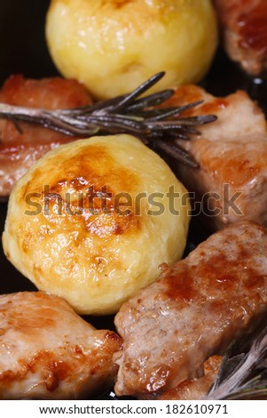 grilled meat and new potatoes closeup. view from above. vertical. macro