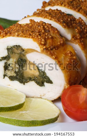 chicken breast stuffed with spinach and cheese macro and fresh cherry tomatoes. vertical