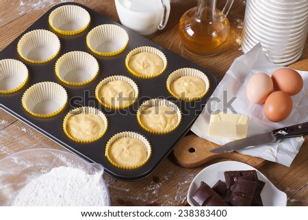 The process of baking the muffins with ingredients close-up horizontal view from above