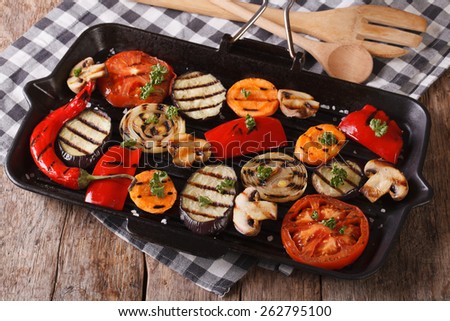 Fresh vegetables cooked in a black skillet grill closeup. Horizontal