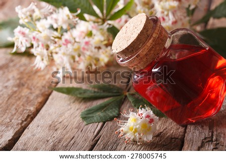 Medicine chestnut flower in a bottle on the table. closeup horizontal