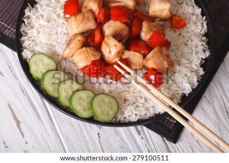 Chinese food: rice with chicken and teriyaki sauce closeup. horizontal view from above