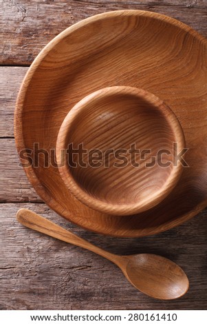 Wooden dish and spoon in a rustic style. vertical view from above