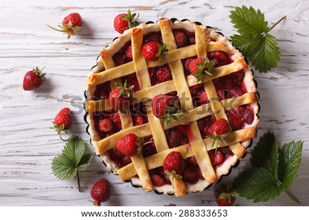 Strawberry pie with fresh berries in baking dish on the table. horizontal view from above, rustic style