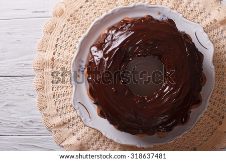 fancy bread cake with chocolate icing on a plate. horizontal view from above
