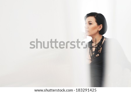 Black haired girl in white room. with blurry optical effects